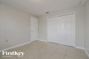 Lehigh Acres house for rent - a bedroom with two closets and a tiled floor
