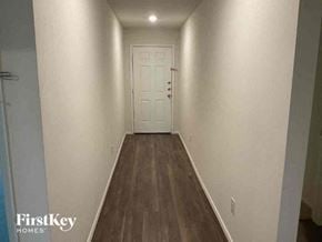 Princeton house for rent - A long hallway with a white door at the end.