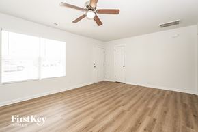High Point house for rent - A room with a ceiling fan and wooden flooring.