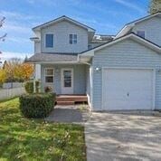 Coeur D Alene house for rent - a white house with a white garage door and a driveway