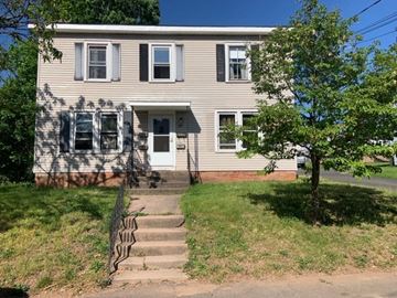 Manchester apartment for rent - a house with stairs and a tree in front of it