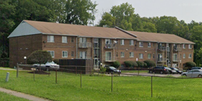 Cincinnati apartment for rent - A large brick apartment building with a parking lot in front.