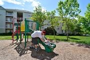 Ashburn apartment for rent - a man playing with a child on a playground