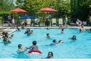 Ashburn apartment for rent - a group of people swimming in a swimming pool