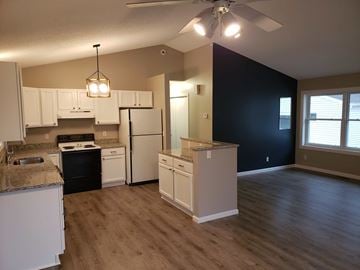 St. Louis Park apartment for rent - a kitchen with white cabinets and a black wall