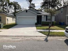 Jacksonville house for rent - a house with a driveway and a white garage door