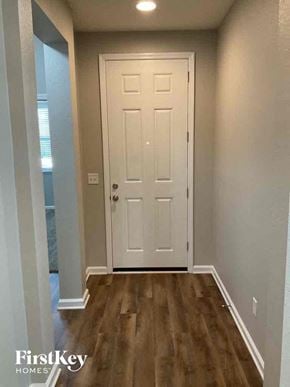 Jacksonville house for rent - a hallway with a white door and wooden floors