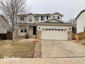Thornton house for rent - a house with a white garage door in front of a driveway