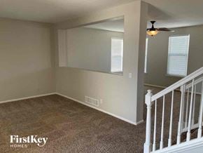 Thornton house for rent - an empty room with a staircase and a ceiling fan