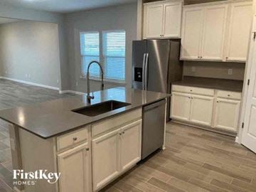 Jacksonville house for rent - A kitchen with a stainless steel refrigerator and a sink.