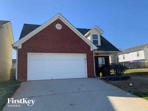 Mcdonough house for rent - a brick house with a white garage door