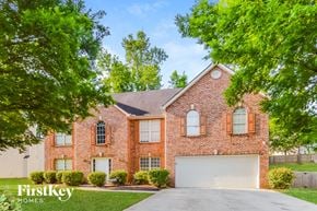 Lithonia house for rent - a brick house with a white garage door