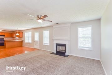 Lithonia house for rent - a living room with a fireplace and a rug