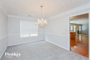 Lithonia house for rent - a empty dining room with a chandelier and a window
