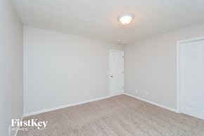 Lithonia house for rent - a bedroom with white walls and carpet and a white door
