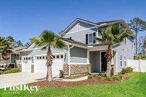 Fernandina Beach house for rent - a blue house with palm trees in front of it