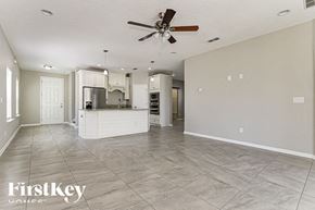 Fernandina Beach house for rent - an empty kitchen and living room with a ceiling fan