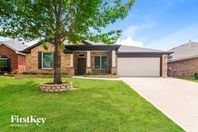 Grand Prairie house for rent - a house with a lawn and a tree in front of it