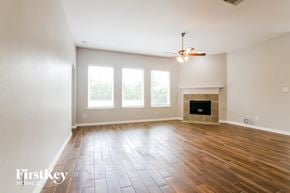 Grand Prairie house for rent - the living room with wood floors and a fireplace