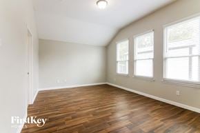 Grand Prairie house for rent - the spacious living room with hardwood flooring and three windows