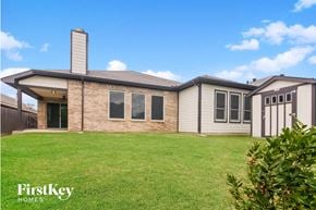 Grand Prairie house for rent - a home with a grassy yard and a house
