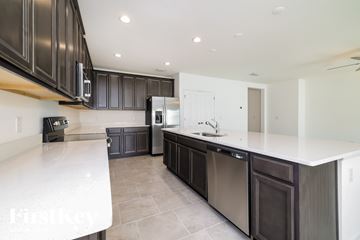 Davenport house for rent - A modern kitchen with dark brown cabinets and stainless steel appliances.