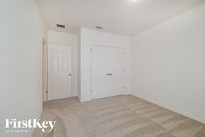 Davenport house for rent - A bedroom with two doors and a carpeted floor.