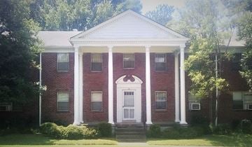 Memphis apartment for rent - a red brick house with white columns and a white door