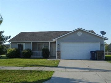 Coeur D'alene house for rent - a house with a white garage door and a driveway