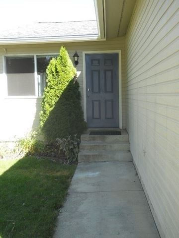 Post Falls house for rent - a blue door on the side of a house