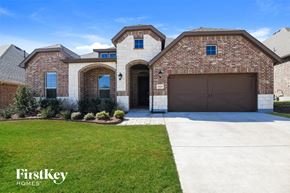 Aledo house for rent - a house with a driveway and a garage door