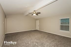 Hockley house for rent - A spacious room with a ceiling fan and carpeted floor.