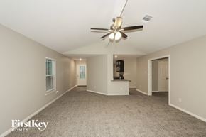 Hockley house for rent - A spacious room with a ceiling fan and a carpeted floor.