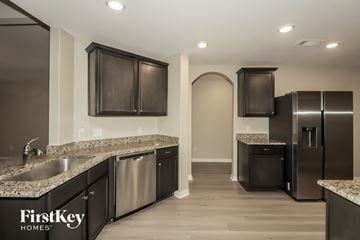 Hockley house for rent - A kitchen with a sink, cabinets, and a refrigerator.