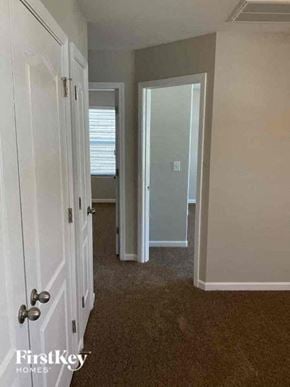 Charlotte house for rent - a hallway with a door to a bedroom and a closet