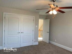 Hampton house for rent - an empty bedroom with a ceiling fan and white doors