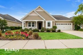 Summerville house for rent - A house with a well-maintained lawn and a clear blue sky.