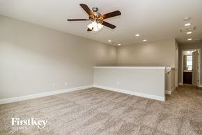 Summerville house for rent - A spacious room with a ceiling fan and carpeted floor.