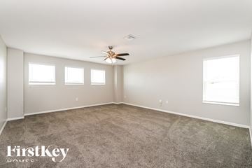 Cape Coral house for rent - a living room with carpet and a ceiling fan