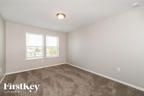 Cape Coral house for rent - a bedroom with carpet and two windows