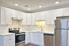 Forest Park apartment for rent - A kitchen with white cabinets and appliances.