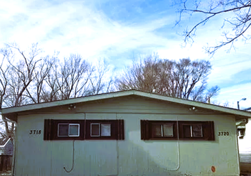 Indianapolis house for rent - a white house with windows with trees in the background
