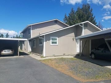 Coeur D' Alene house for rent - a beige house with a parking lot and a car garage