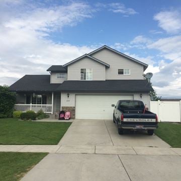 Post Falls apartment for rent - A black Chevrolet truck is parked in front of a house.