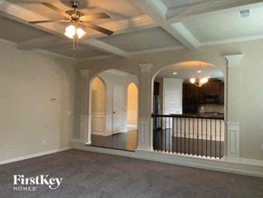 Conyers house for rent - an empty living room with a ceiling fan