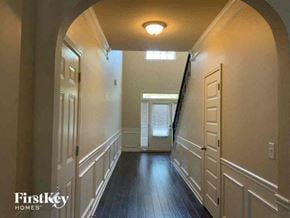 Conyers house for rent - a hallway with a wood floor and a white door
