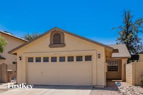 Phoenix house for rent - A two-car garage is attached to a house.