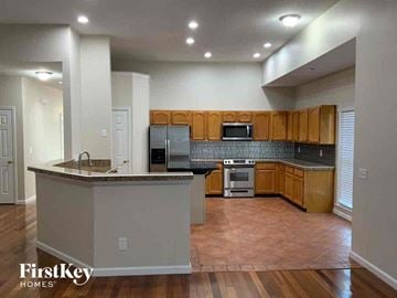 Indian Trail house for rent - an empty kitchen with wooden cabinets and a counter top