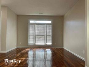Indian Trail house for rent - an empty living room with wood floors and a window