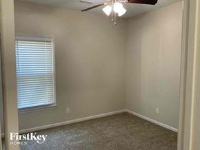 Indian Trail house for rent - an empty bedroom with a ceiling fan and a window